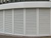 By slightly angling each section of the shutter, this curved opening has been secured with traditional steel roller shutters.