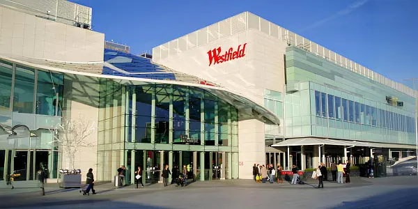 Exterior of Westfield London Shopping Centre in Shepherd's Bush, showcasing its modern architecture on a sunny winter's day.
