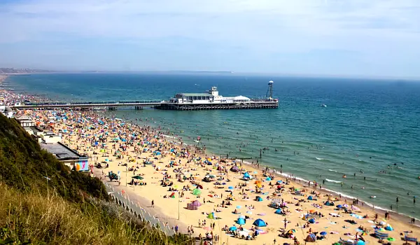 Bournemouth pier and beach with beachgoers in Summer