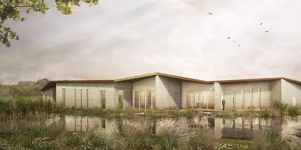 Impression of the exterior of the new Plymouth crematorium with a pond and nature around the building