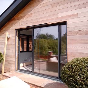 sliding glass doors in the facade of a building
