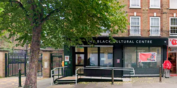 Front entrance of the Black Cultural Centre in Islington, with one Armourshield security roller shutter up and another one rolled down in front of the window