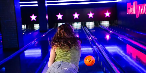 Woman throwing a ball in a bowling alley