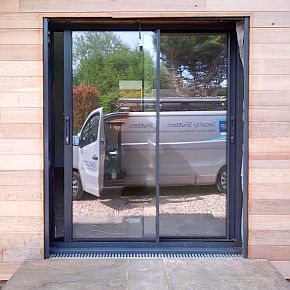 open roller shutter showing windowed doors