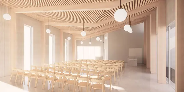 Impression of the inside of one of the halls of the new Plymouth crematorium rows of chairs in an open space with large windows letting in lots of natural daylight