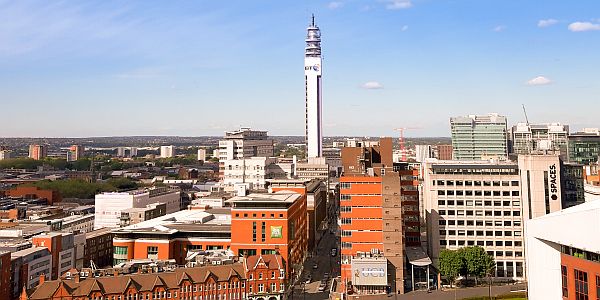 panorama over the city of Birmingham with flats, red-bricked buildings and a high communication tower
