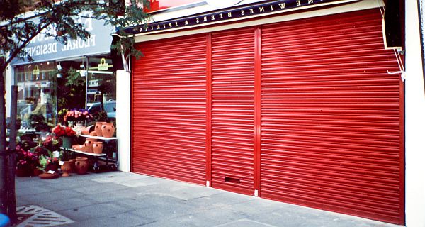 Red rolling shutter door over shopfront