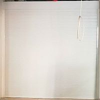 White aluminium roller shutter seen from the front