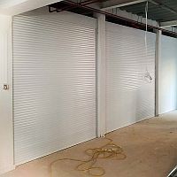 Sideview of a set of three roller shutters in Sidmouth College