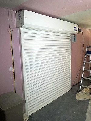 a white roller shutter being serviced